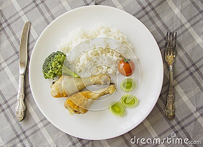 Chicken greek legs with rice on served table Stock Photo