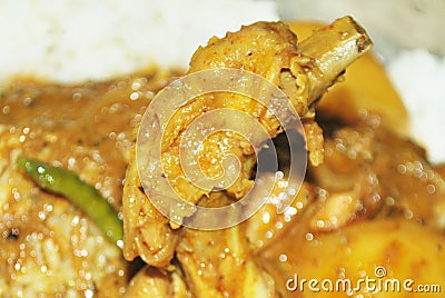 Chicken leg cooked very well . potato & other ingredients . Indian cooking method . Stock Photo