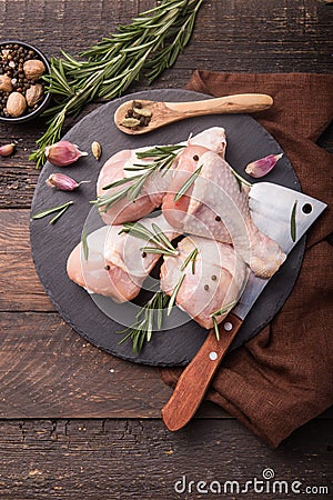Chicken meat - Raw uncooked drumsticks or legs on slate with ingredients for cooking. Top view Stock Photo