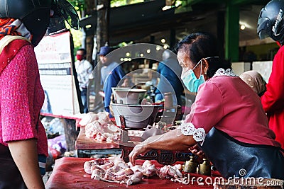 Chicken meat seller wearing masks at Giwangan Market Editorial Stock Photo