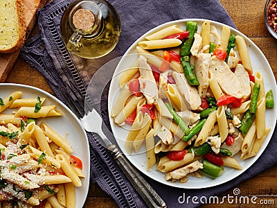 Chicken penne pasta with red bell peppers and asparagus Stock Photo