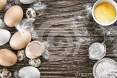 Chicken and quail eggs. Ingredients for cooking. Wooden table. T Stock Photo