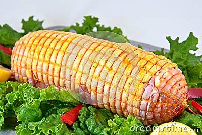 Chicken rolled meat enclosed in tied netting Stock Photo