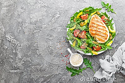 Chicken salad. Meat salad with fresh tomato, sweet pepper, arugula and grilled chicken breast. Chicken fillet with fresh vegetable Stock Photo