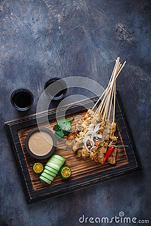 Chicken Satay or Sate Ayam - Malaysian famous food. Is a dish of seasoned, skewered and grilled meat, served with a Stock Photo