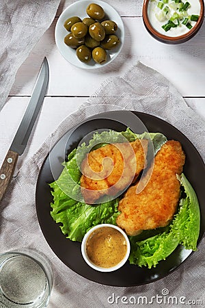 Chicken schnitzel and lettuce with olives Stock Photo