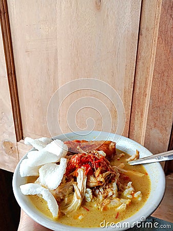 Chicken soup in a bowl. Soto ayam is a typical Indonesian food in the form of a type of chicken soup with a yellowish sauce. Stock Photo