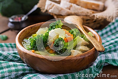 Chicken soup with broccoli, green peas, carrots and celery Stock Photo