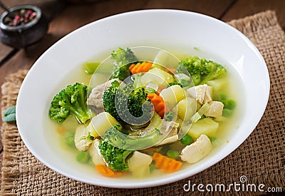 Chicken soup with broccoli, green peas, carrots and celery Stock Photo