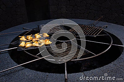 Chicken steaks grill on natural volcanic circular oven Stock Photo