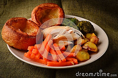 Chicken Sunday dinner with Yorkshire puddings Stock Photo