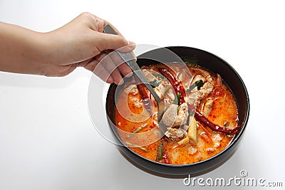 Chicken tomyum the favourite spicy food in thailand with spoon a Stock Photo