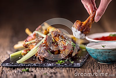 Chicken wings. Fried chicken wings in white bowl garlic dressing ketchup and potato fries Stock Photo