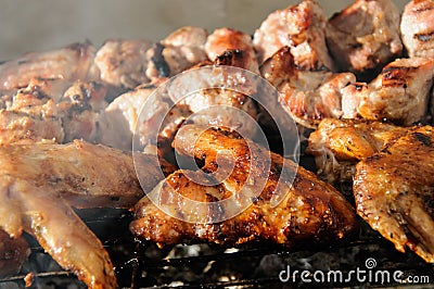 Chicken wings and Juicy roasted kebabs and on the BBQ Stock Photo