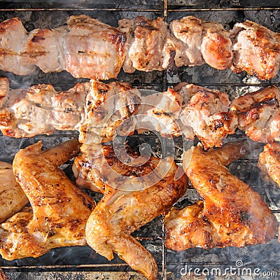 Chicken wings and Juicy roasted kebabs and on the BBQ Stock Photo
