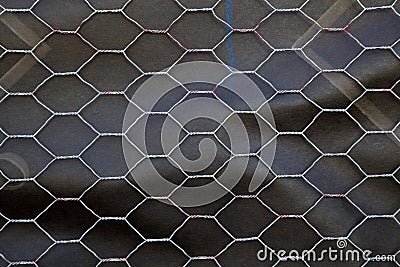 Chicken wire over roofing paper Stock Photo