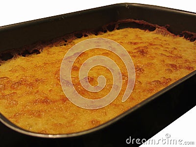 Chickpea flour pancake in a tray isolated on white background. The pancake is known as Cecina in Tuscany or Farinata in Liguria Stock Photo