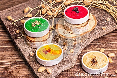 Chickpea hummus backdrop, assorted flavor on vintage wooden table Stock Photo