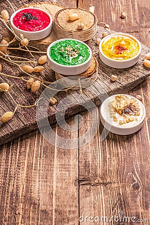 Chickpea hummus backdrop, assorted flavor on vintage wooden table Stock Photo