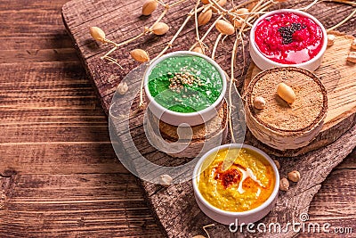 Chickpea hummus backdrop, assorted flavor on vintage wooden table Stock Photo