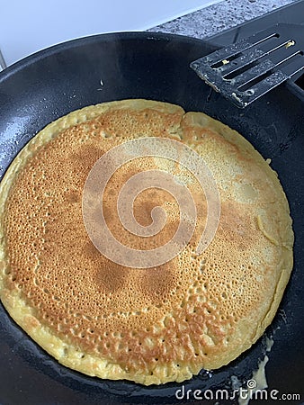 Chickpea pancake in the frying pan Stock Photo