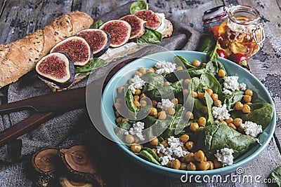Chickpea and veggies salad with spinach leaves, homemade cheese,healthy vegan food,sandwich with figs, diet dish Stock Photo