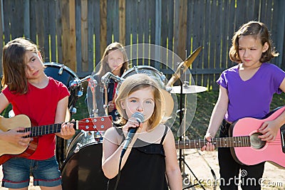Chidren singer girl singing playing live band in backyard Stock Photo