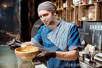 Chief cook at the asian restaurant kitchen Stock Photo