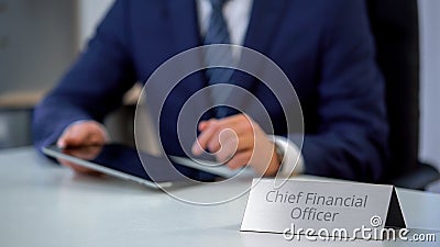 Chief financial officer of corporation using tablet pc, planning company budget Stock Photo