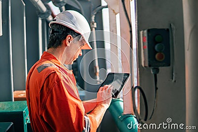 Chief officer or captain on deck of vessel or ship watching digital tablet Stock Photo