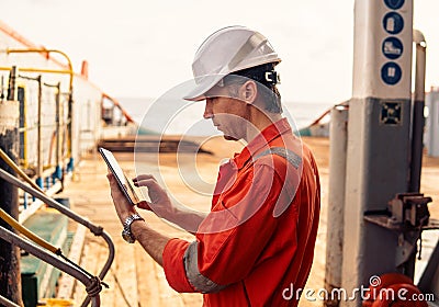 Chief officer or captain on deck of vessel or ship watching digital tablet Stock Photo