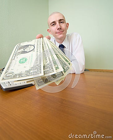 Chief stretching to us a pack of dollars Stock Photo