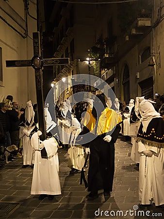 Hooded faithful carry the symbols of Christ's passion in procession in the oldest procession in Italy Editorial Stock Photo