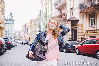 Chihuahua dog carried in pet bag. Cute dog in transparent pet travel carrier. Caucasian woman holding a carrying bag with pet on Stock Photo