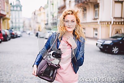 Chihuahua dog carried in pet bag. Cute dog in transparent pet travel carrier. Caucasian woman holding a carrying bag with pet on Stock Photo