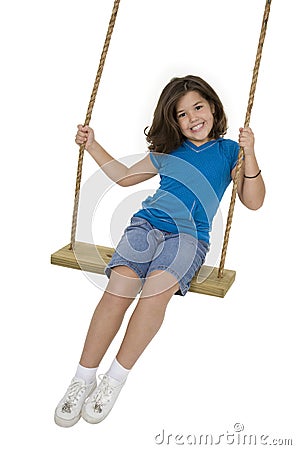 Cute Caucasian child playing on a wooden swing Stock Photo