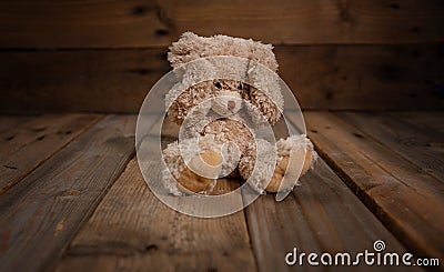 Child abuse.Teddy bear covering eyes, dark empty background, copy space Stock Photo