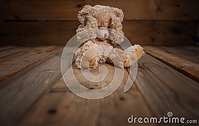 Child abuse.Teddy bear covering eyes, dark empty background, copy space Stock Photo