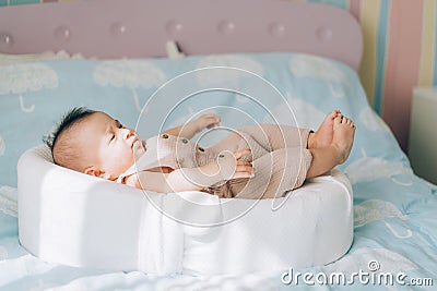 Child adoption and In Vitro Fertilization IVF . Asian child lying on the bed. Caring for newborn children Stock Photo