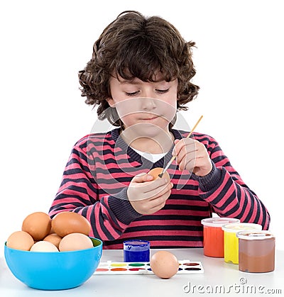 Child adorable adorning Easter eggs Stock Photo