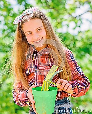 Child adorable kid hold flower pot and hoe gardening tool. Gardening is peaceful meditative occupation. Gardening Stock Photo