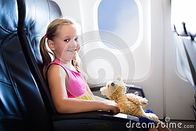 Child in airplane. Flight with kids. Family flying. Stock Photo