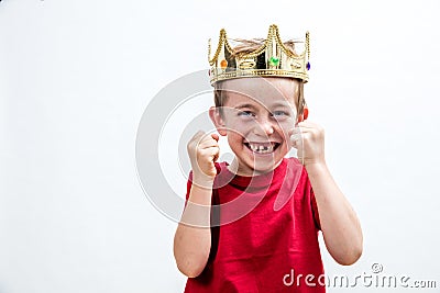 Child attitude with giggling young spoiled boy with a crown Stock Photo