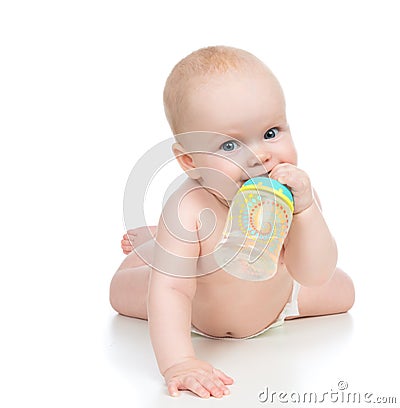 Child baby girl lying happy holding breastfeeding bottle nipple Stock Photo