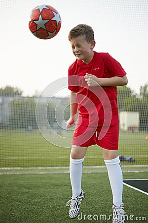 Child with Ball on the sport field. Football player Stock Photo