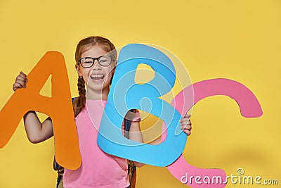 Child with big letters Stock Photo