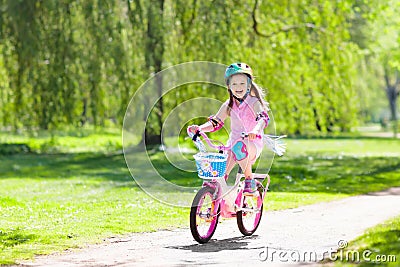 Child on bike. Kids ride bicycle. Girl cycling. Stock Photo