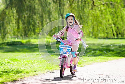 Child on bike. Kids ride bicycle. Girl cycling. Stock Photo