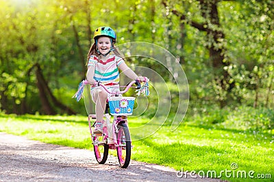 Child on bike. Kids ride bicycle. Girl cycling. Stock Photo