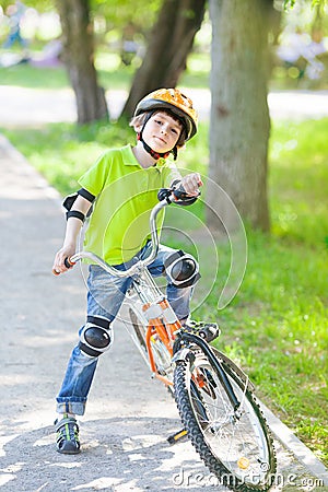 Child with bike stands on cycle lane Stock Photo